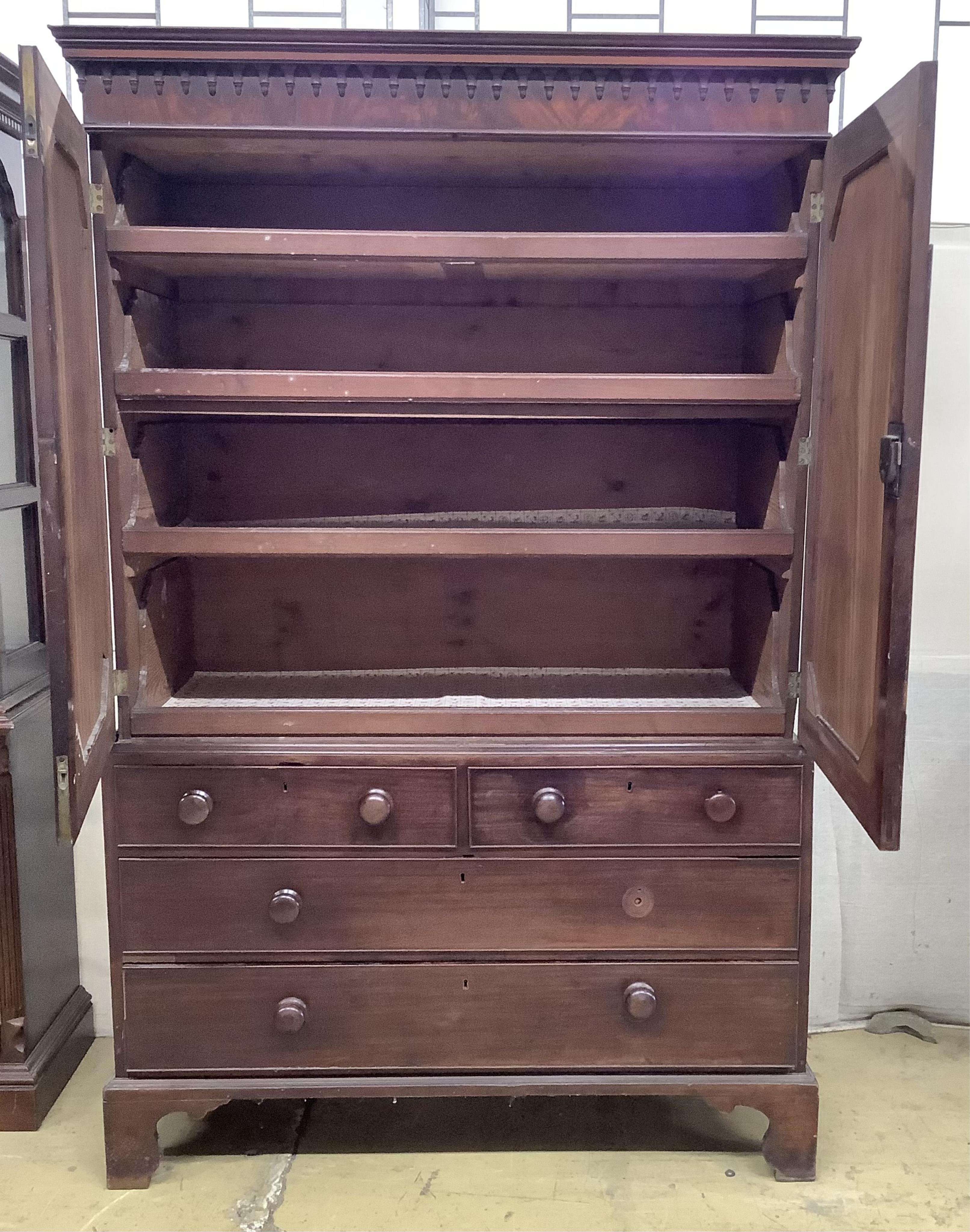 A George III mahogany linen press, the top retaining the original sliding trays, width 129cm, depth 56cm, height 201cm. Condition - poor